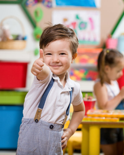 little boy doing thumbs up