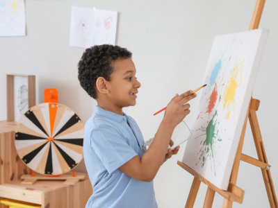 young boy doing painting