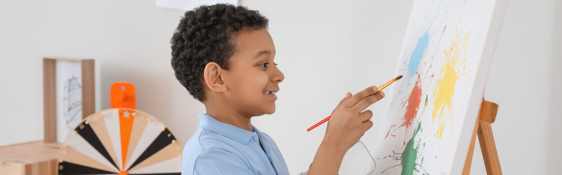 young boy doing painting